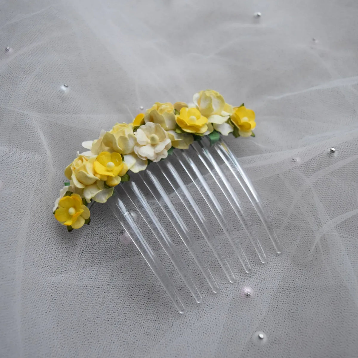 Ballet French twist clear hair comb with yellow and white floral design on a white background