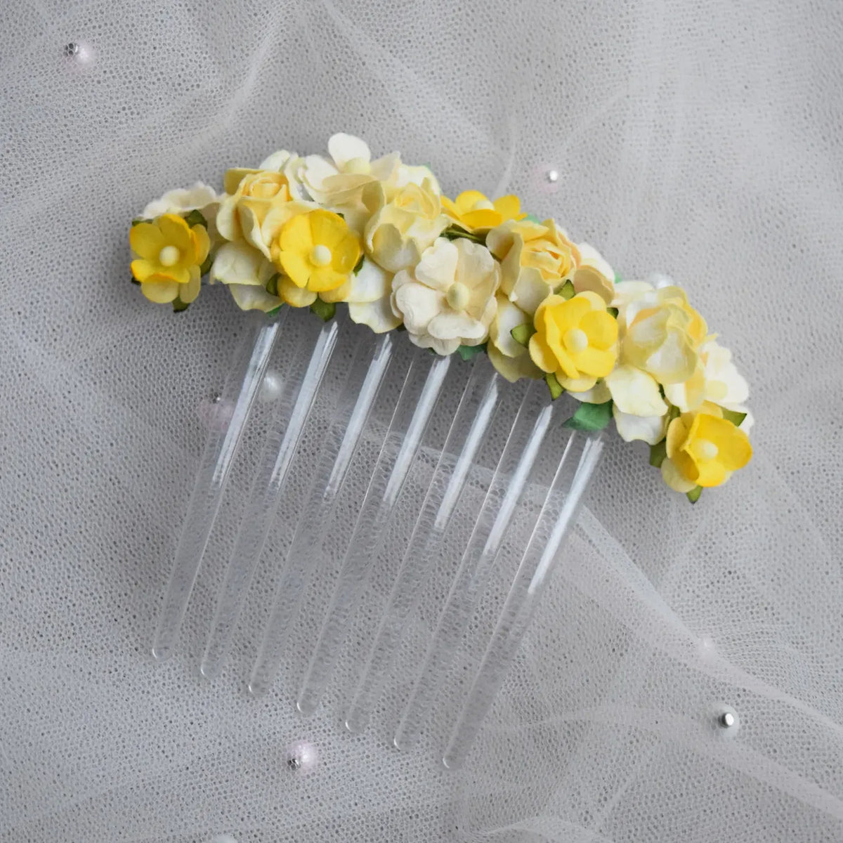 Ballet French twist clear hair comb with yellow and white floral design on a white background