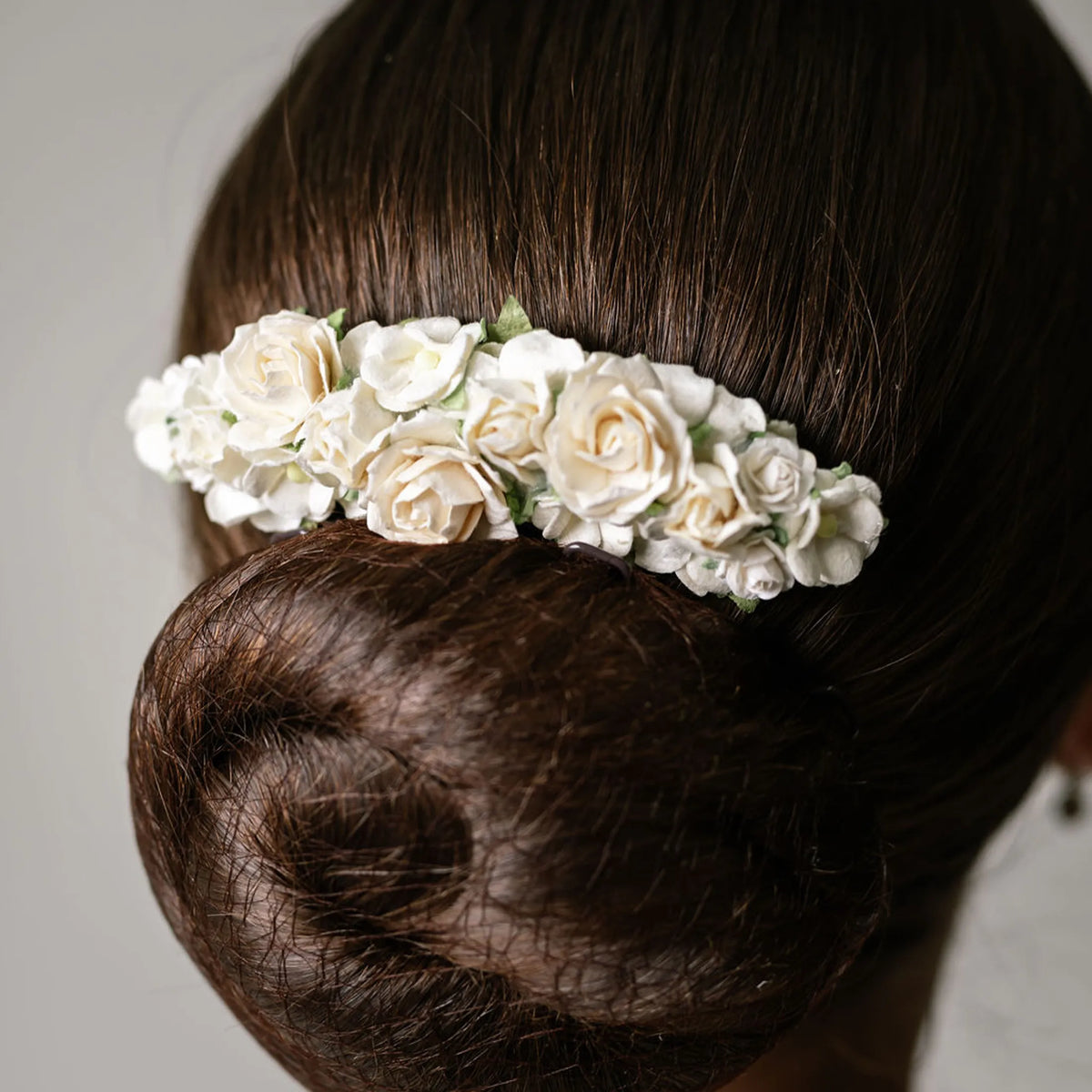 Ballet French twist clear hair comb with a white floral design on a bun