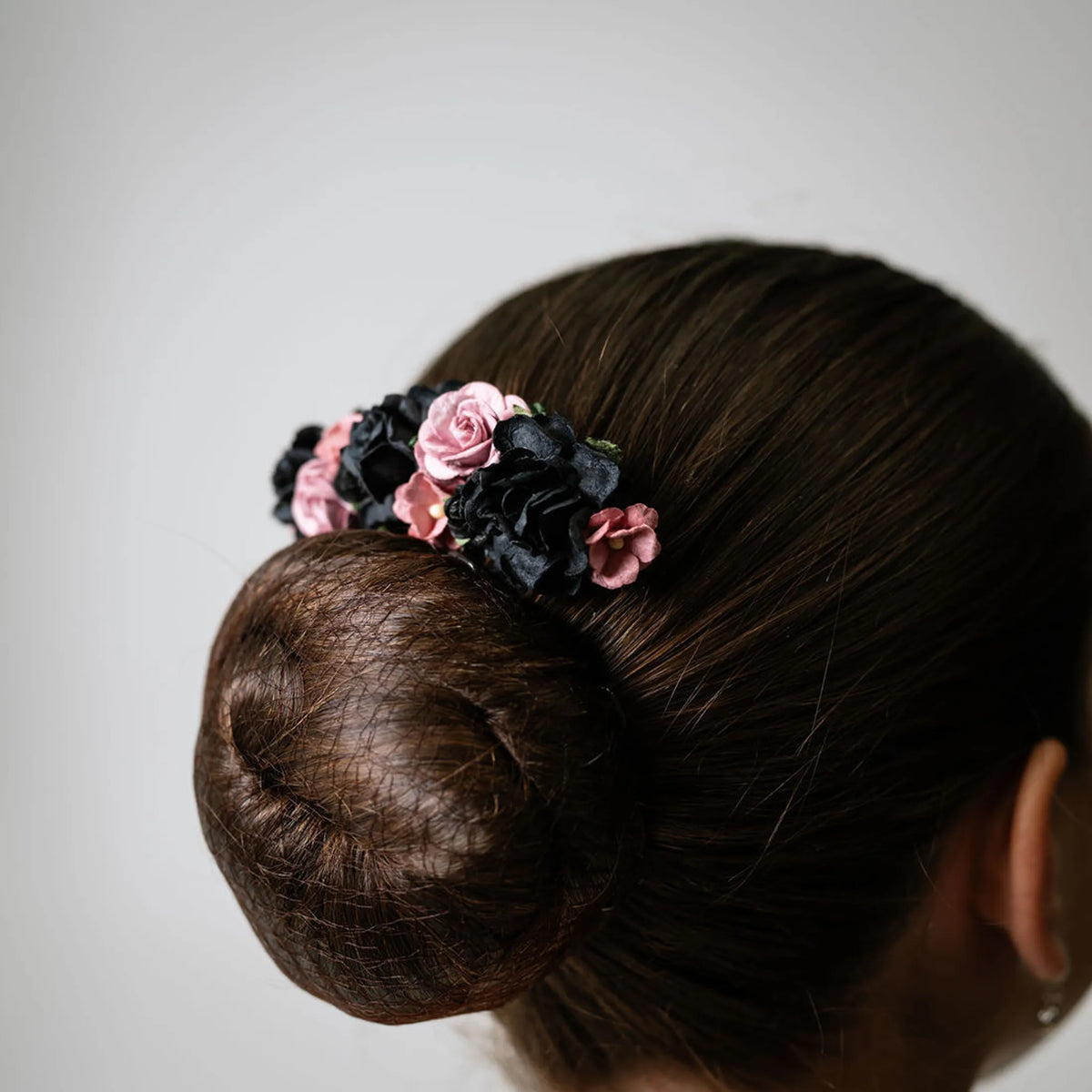Ballet French twist clear hair comb with a black and burgundy floral design on a bun