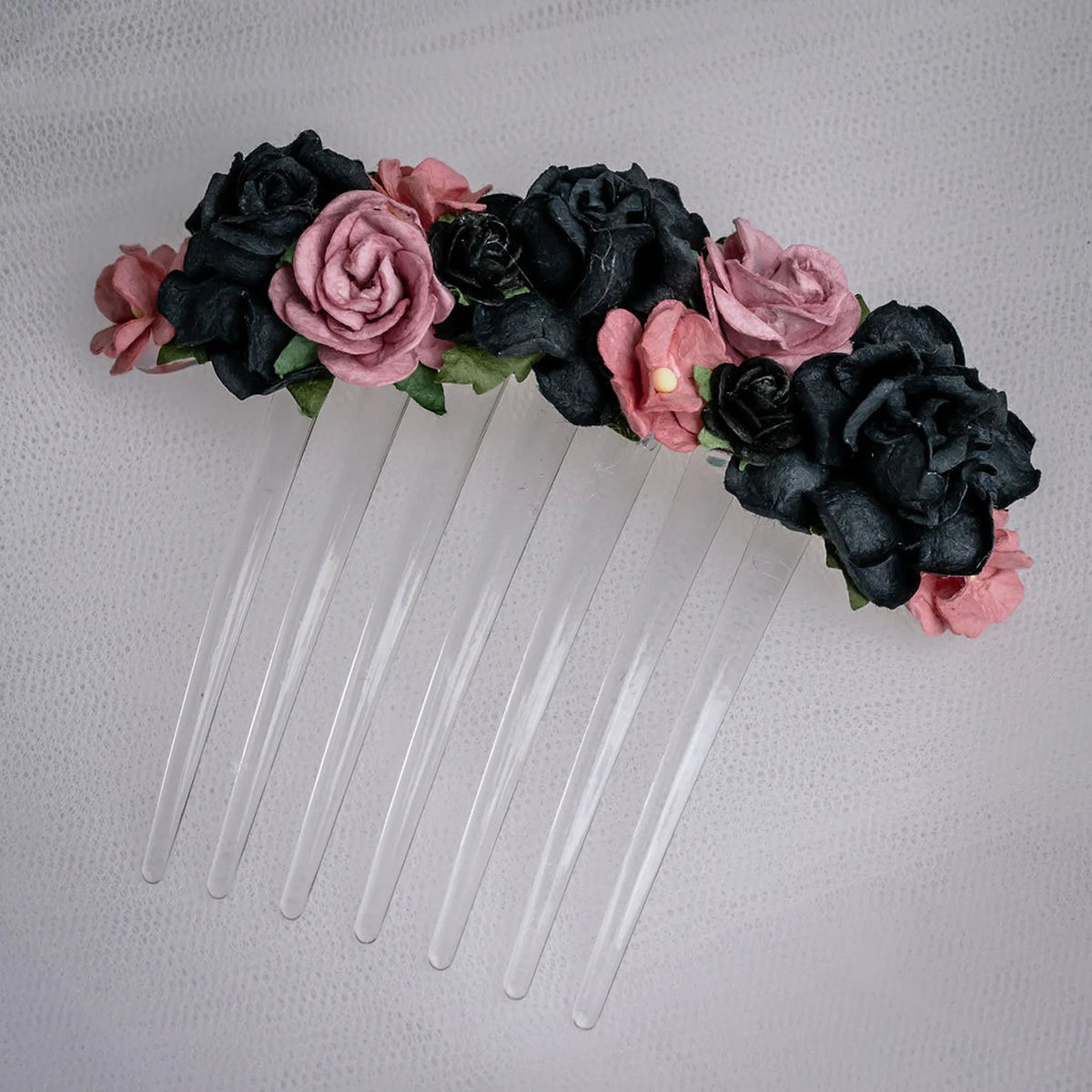 Ballet French twist clear hair comb with a black and burgundy floral design on a white background