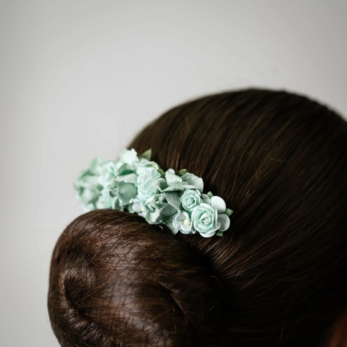 Ballet French twist hair comb with a mint green floral design on a bun