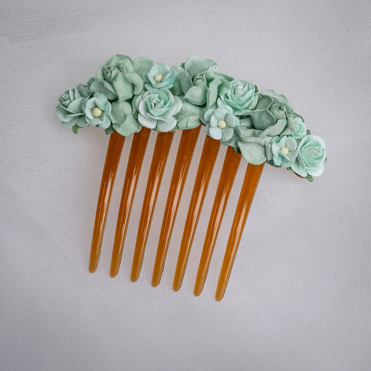 Ballet French twist brown hair comb with a mint green floral design on a white background