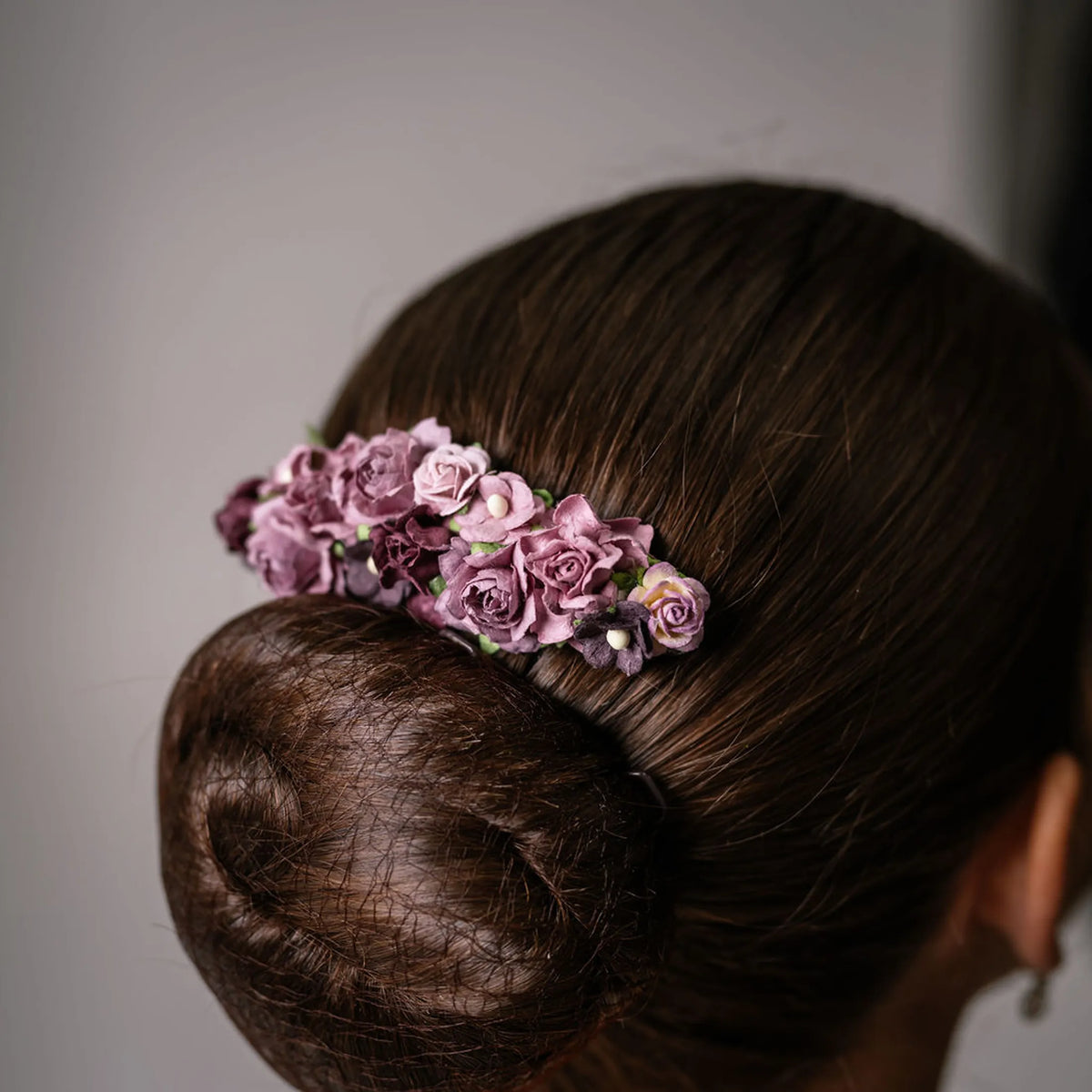 Ballet French twist clear hair comb with a purple floral design on a bun