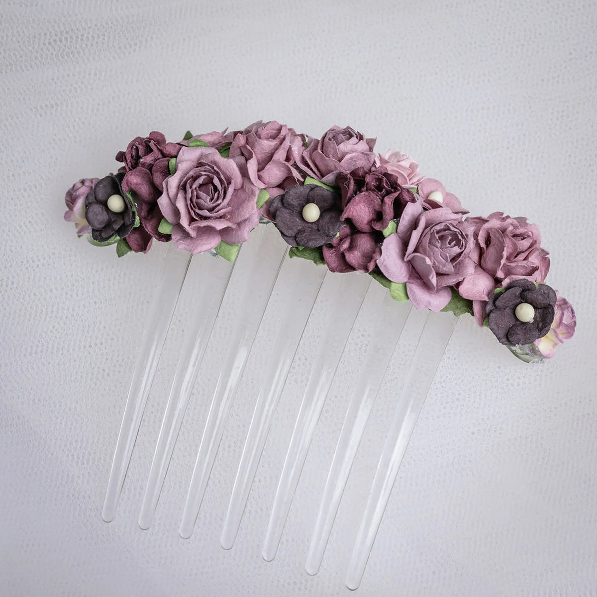 Ballet French twist clear hair comb with a purple floral design on a white background