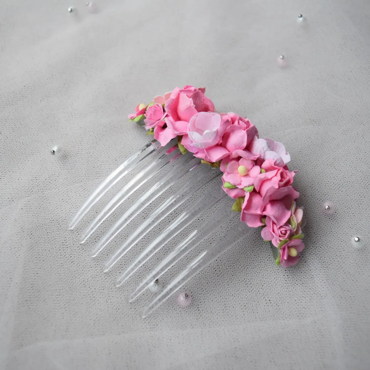 Ballet French twist clear hair comb with pink rose floral design on a white background