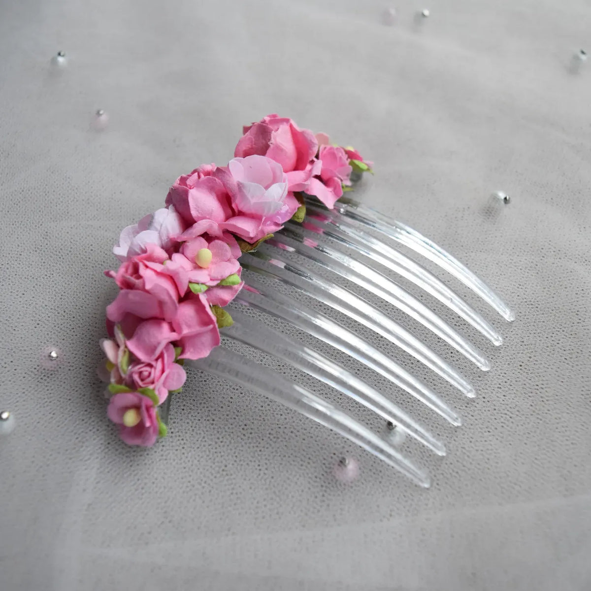 Ballet French twist clear hair comb with pink rose floral design on a white background