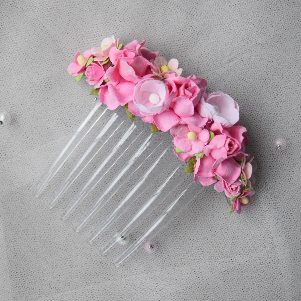 Ballet French twist clear hair comb with pink rose floral design on a white background