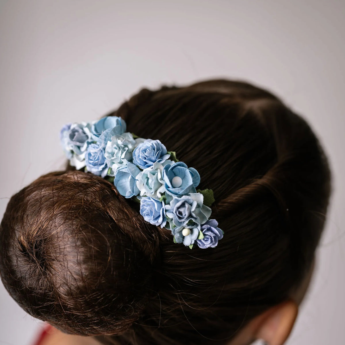 Ballet French twist clear hair comb with a light blue floral design on a bun