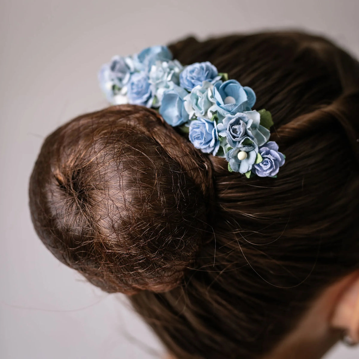 Ballet French twist clear hair comb with a light blue floral design on a bun