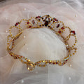 Decorative tiara with gemstones on a sheer fabric background